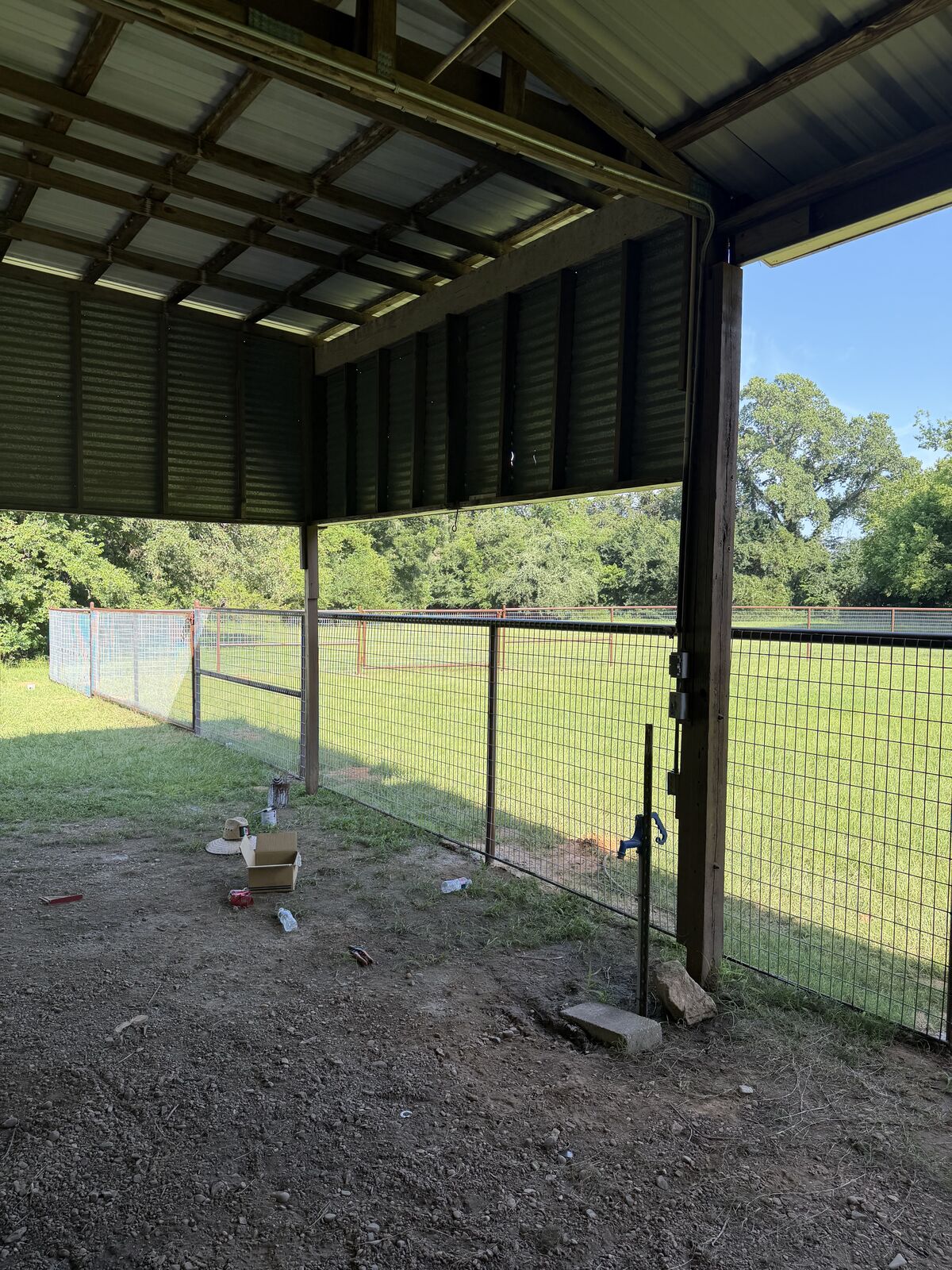 Wire fence panels built under a metal barn shelter
